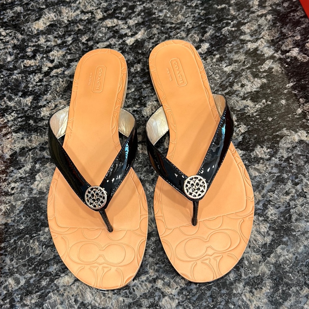 New. Coach black patent sandals.